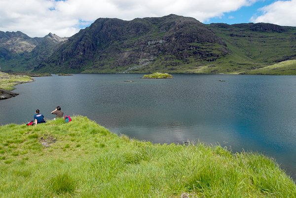 Hikers rest and enjoy the view. Stock photo of Loch Coriusk on the Isle of Skye, Scotland. Part of the Britain Express Travel and Heritage Picture Library, Scotland collection.