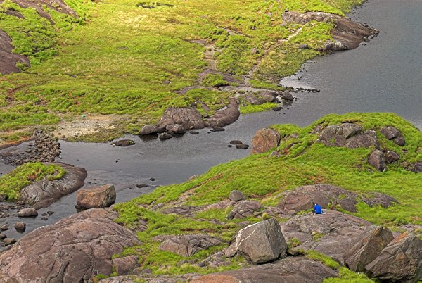 Photo of the rocky shoreline of Loch Coriusk on the Isle of Skye, Scotland, in the heart of the Black Cuillins.