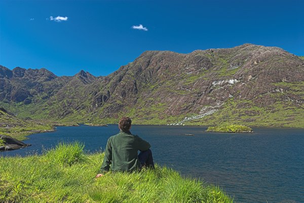 What a spot to sit and soak up the ambience! Blue water and blue skies at Loch Coriusk. Stock photo of the Isle of Skye, Scotland. Part of the Britain Express Travel and Heritage Picture Library, Scotland collection.