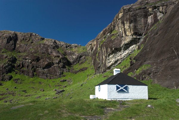 A rambler's hut perches under the Black Cuillins near Loch Coriusk. Note the shutter painted with the Scottish flag. Stock photo of Loch Coriusk on the Isle of Skye, Scotland. Part of the Britain Express Travel and Heritage Picture Library, Scotland collection.