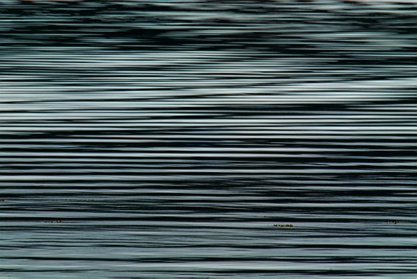 Ripples in the water create strong horizontal patterns of light and shade. Stock photo of Portree on the Isle of Skye, Scotland. Part of the Britain Express Travel and Heritage Picture Library, Scotland collection.