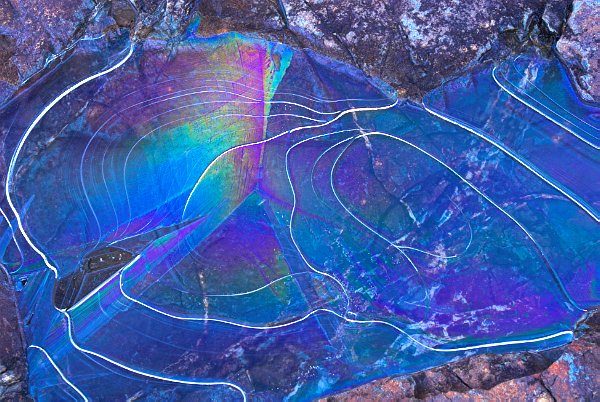 Rainbow streaked ripples in ice. Stock photo of Sligachan on the Isle of Skye, Scotland. Part of the Britain Express Travel and Heritage Picture Library, Scotland collection.