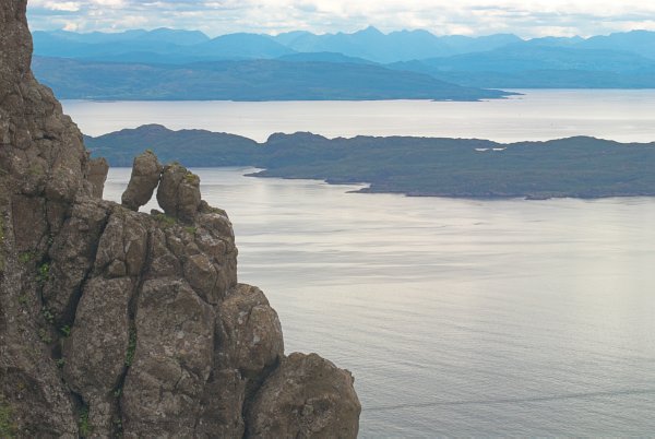 Cuddling rocks have a romantic ocean view. Rock formations at Storr. Stock photo of Storr on the Isle of Skye, Scotland. Part of the Britain Express Travel and Heritage Picture Library, Scotland collection.
