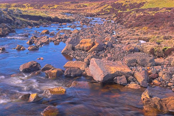 A high rocky burn winds along the elevated plateau above Uig. Stock photo of Uig on the Isle of Skye, Scotland. Part of the Britain Express Travel and Heritage Picture Library, Scotland collection.