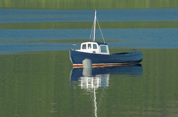 Boat bobbing in the harbour at Stein, Waternish. Stock photo of the coast at Stein on the Isle of Skye, Scotland. Part of the Britain Express Travel and Heritage Picture Library, Scotland collection.